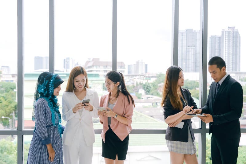 Business People Meeting Discussion Working and talking in office. Young people using smart phones at workplace. stock photos