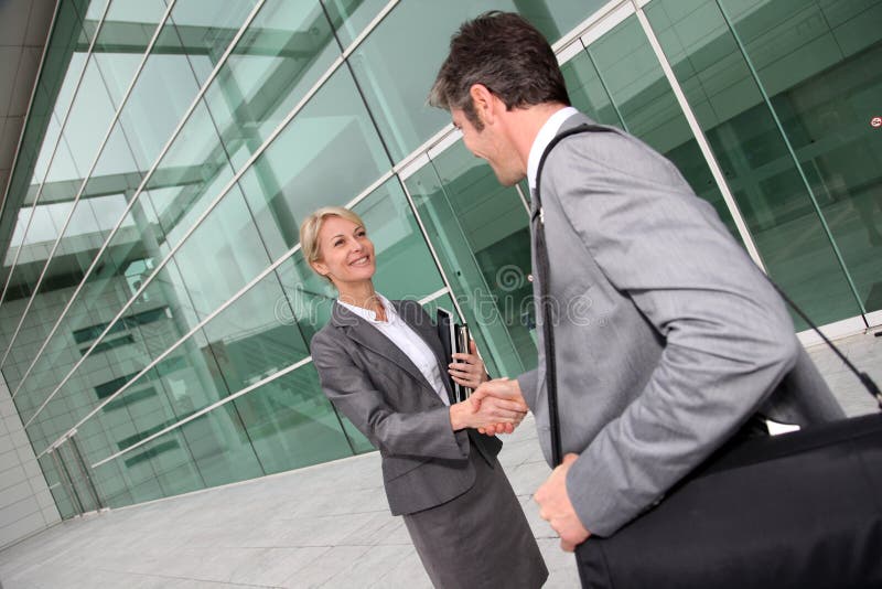 Business people meeting in front of office building