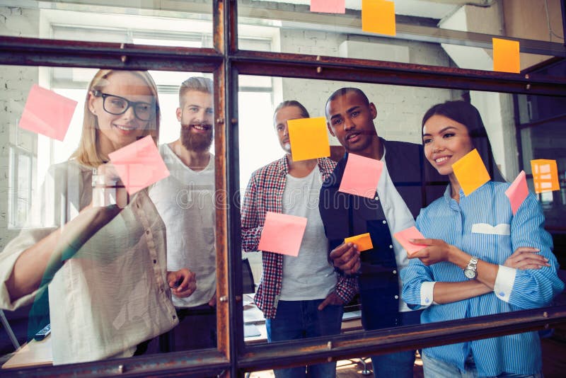 Business people meeting at office and use post it notes to share idea. Brainstorming concept. Sticky note on glass wall stock photos Business people meeting at office and use post it notes to share idea. Brainstorming concept. Sticky note on glass wall stock photos