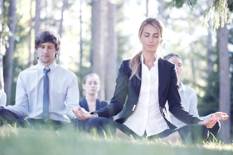 Business people practicing yoga stock photography
