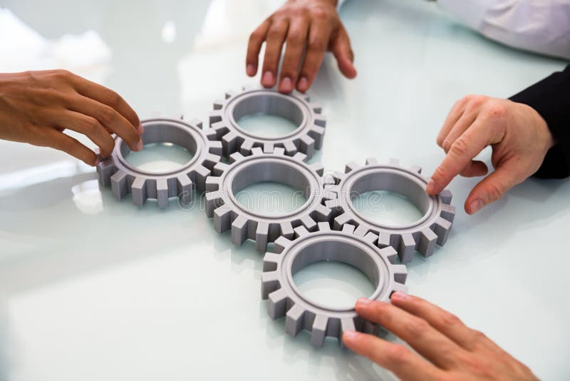 Business People`s Hand Connecting Gears