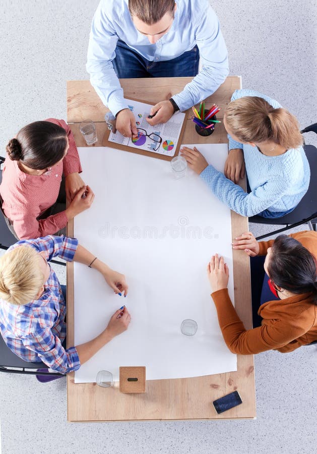 Business people sitting and discussing at meeting, in office stock images Business people sitting and discussing at meeting, in office stock images