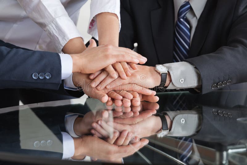 Business people stacking hands stock photo