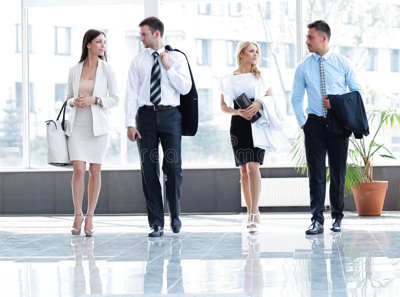 Business people standing in the lobby of the modern office.