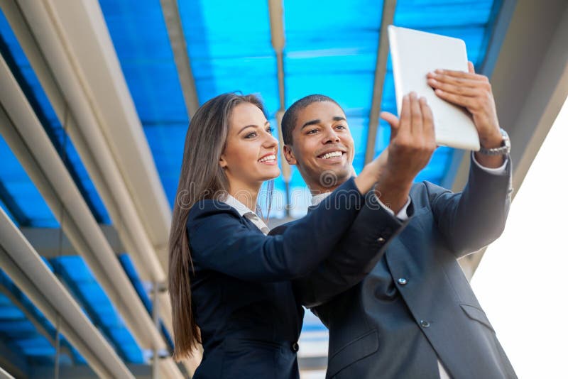 Business people taking selfie and looking at digital tablet stock image Business people taking selfie and looking at digital tablet stock image
