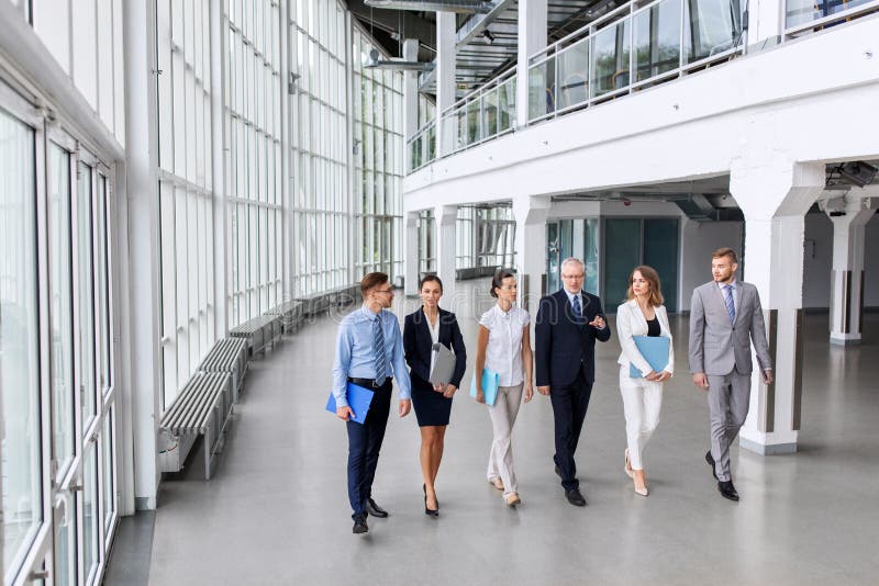 Business people walking along office building royalty free stock photography Business people walking along office building royalty free stock photography