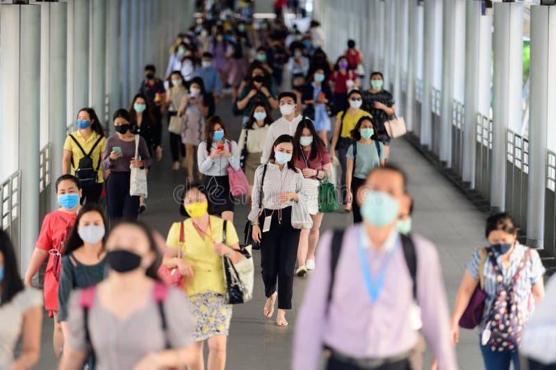 Business people wearing surgical mask for prevent coronavirus outbreak in rush hour at Bangkok stock photo Business people wearing surgical mask for prevent coronavirus outbreak in rush hour at Bangkok stock photo