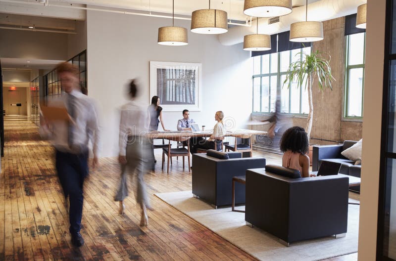 Business people at work in a busy luxury office space stock photo