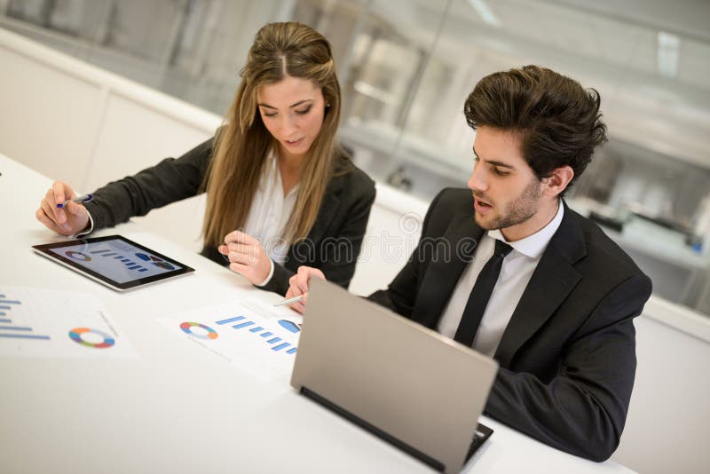 Business people working around table in modern office royalty free stock image Business people working around table in modern office royalty free stock image