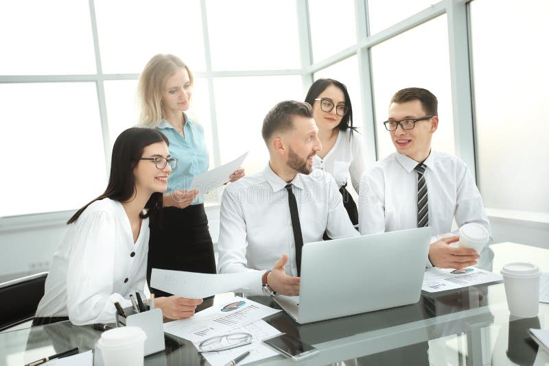 Business people working and communicating while sitting at the office desk stock images Business people working and communicating while sitting at the office desk stock images
