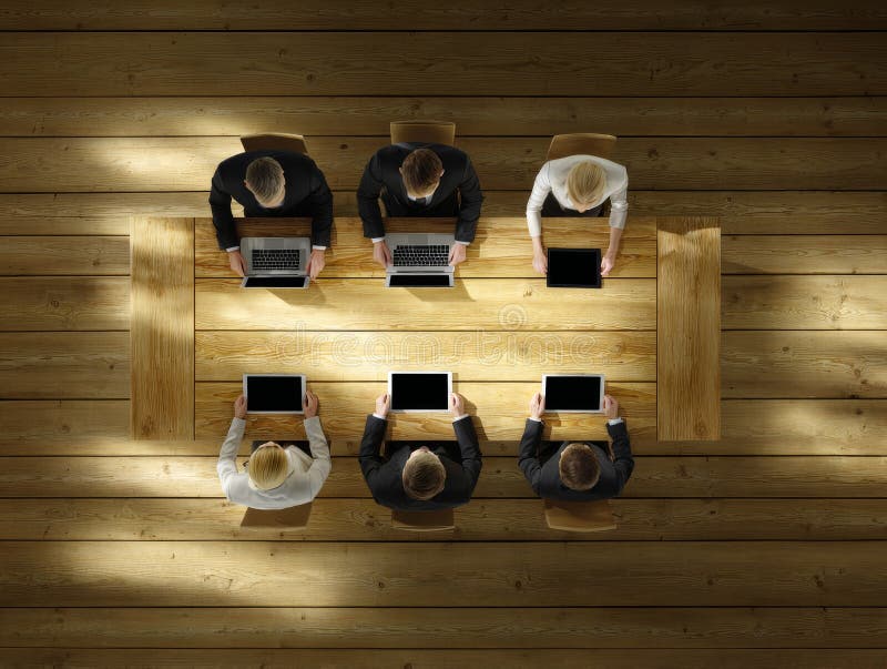 Business people working on laptops and tablets in meeting royalty free illustration
