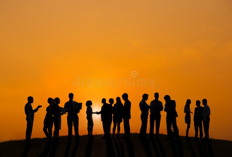 Business People Working Outdoors With A View Of Sunset stock photo Business People Working Outdoors With A View Of Sunset stock photo