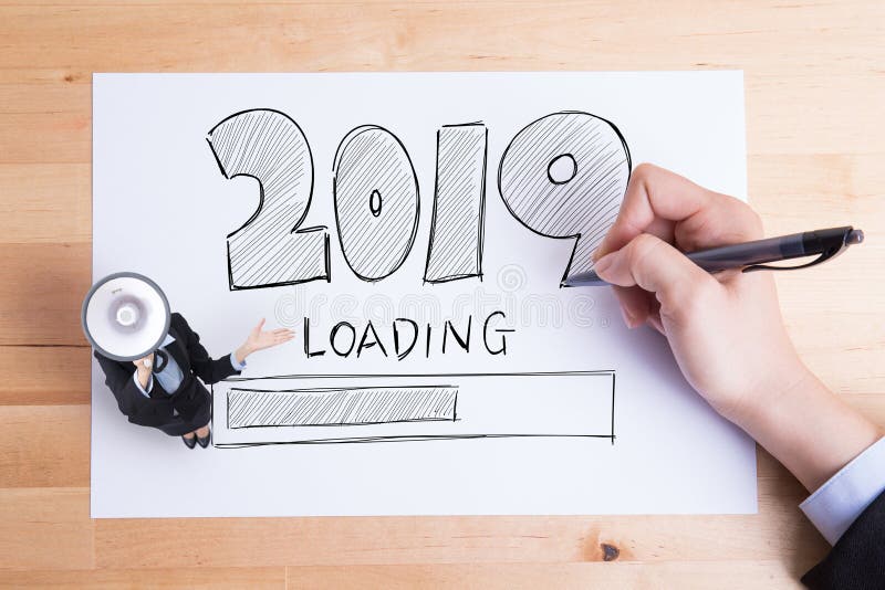 Business people writing 2019 loading text on the paper and woman take megaphone stock photography Business people writing 2019 loading text on the paper and woman take megaphone stock photography