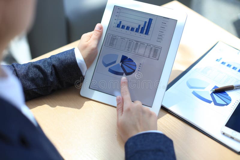 Business person analyzing financial statistics stock images