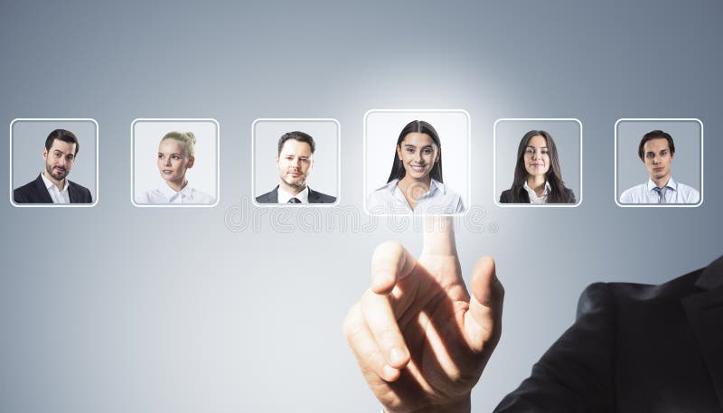 Business person selecting professional profile from digital employee interface on light background with multiple headshots of royalty free stock photography
