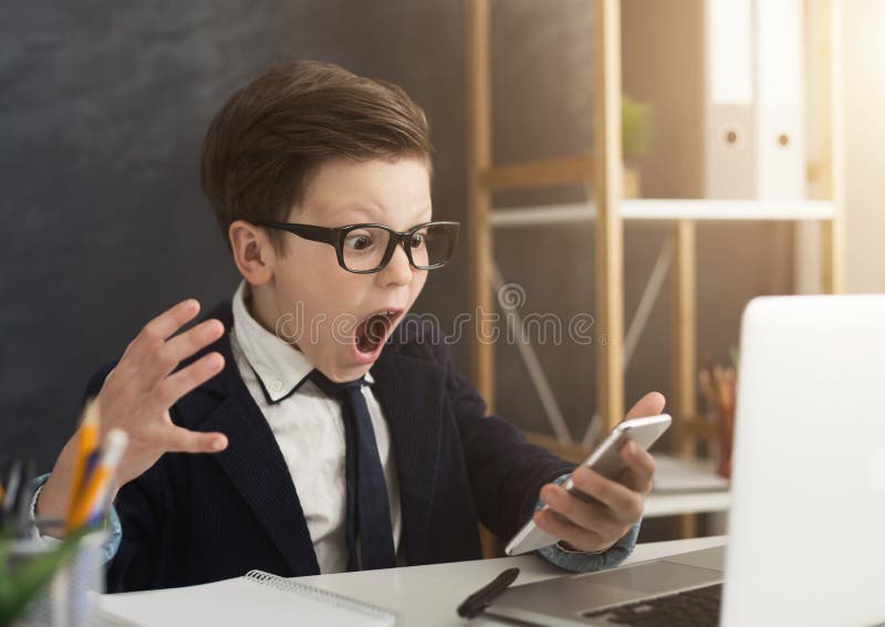 Emotional business boy screaming at smartphone royalty free stock images Emotional business boy screaming at smartphone royalty free stock images