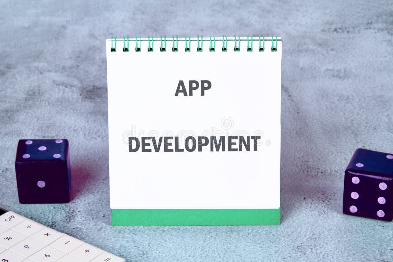 Business, programming, interface, application and network concept. Text APP DEVELOPMENT on an upright notepad royalty free stock photos
