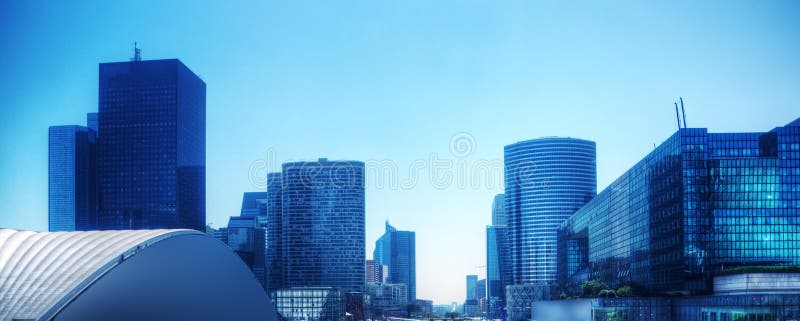 Business skyscrapers panorama in blue tint. Paris, France