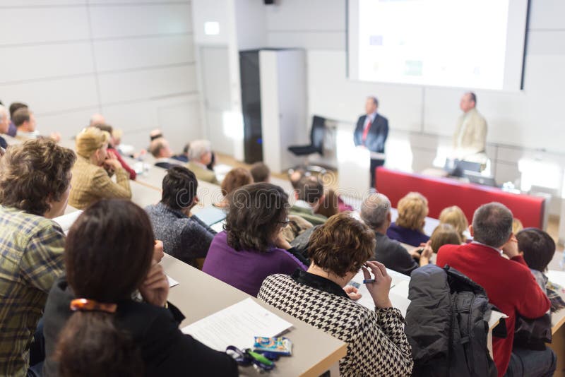 Business speaker giving a talk at business conference event.