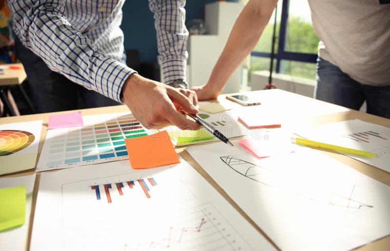 Business team brainstorming. Marketing plan researching. Paperwork on the table, laptop and mobilephone stock photography Business team brainstorming. Marketing plan researching. Paperwork on the table, laptop and mobilephone stock photography