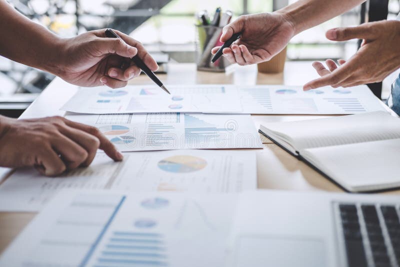 Business team colleagues discussing working analysis with financial data and marketing growth report graph in team, Meeting stock image