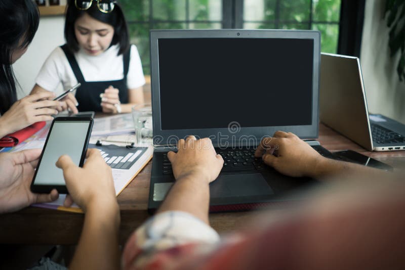 Business team colleagues working on office table with laptop and royalty free stock photo Business team colleagues working on office table with laptop and royalty free stock photo