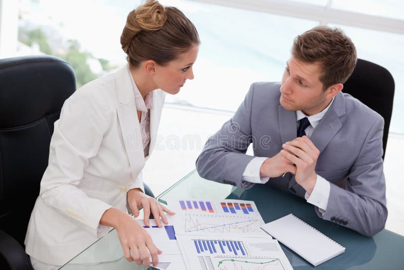 Business team deliberating on market research stock images Business team deliberating on market research stock images