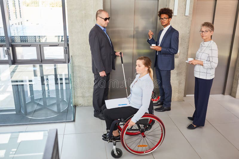 Business team with disabled colleagues at the elevator stock photo