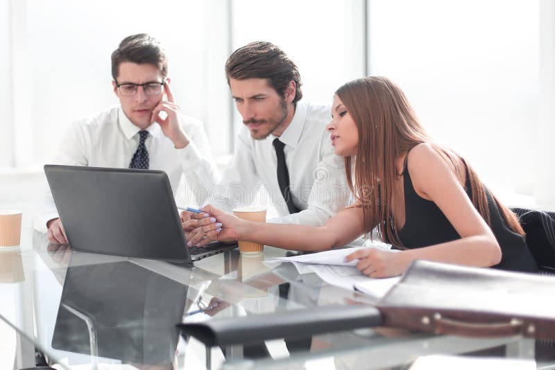 Business team discussing online information in the office stock photo Business team discussing online information in the office stock photo
