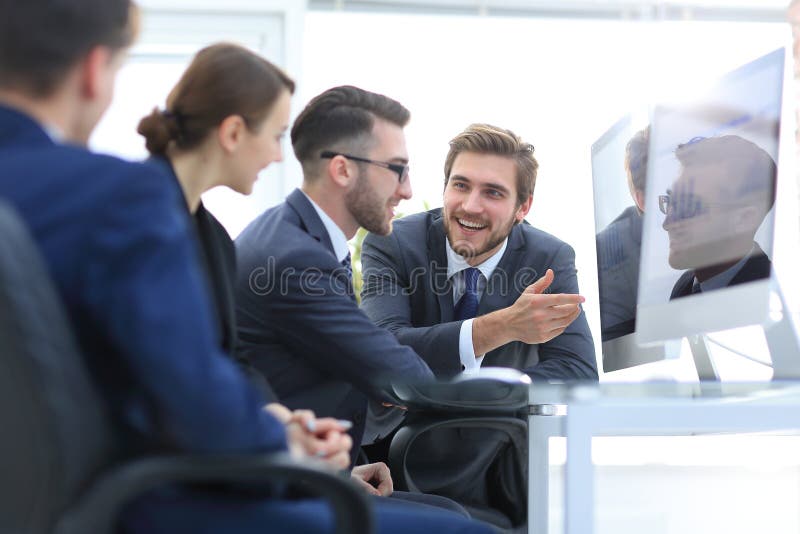 Business team discussing while sitting at their Desk stock images Business team discussing while sitting at their Desk stock images