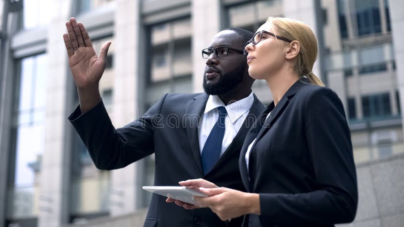 Business team of engineers discussing architectural design, using digital tablet stock photo Business team of engineers discussing architectural design, using digital tablet stock photo