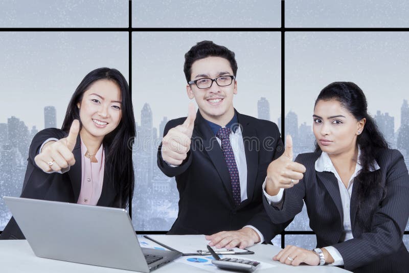 Business team giving thumb stock photo Business team giving thumb stock photo