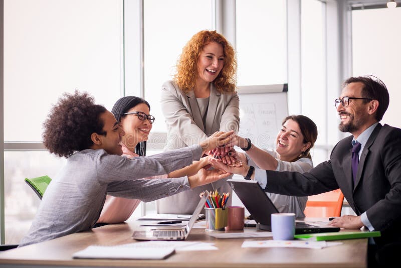 Business team holding hands together.