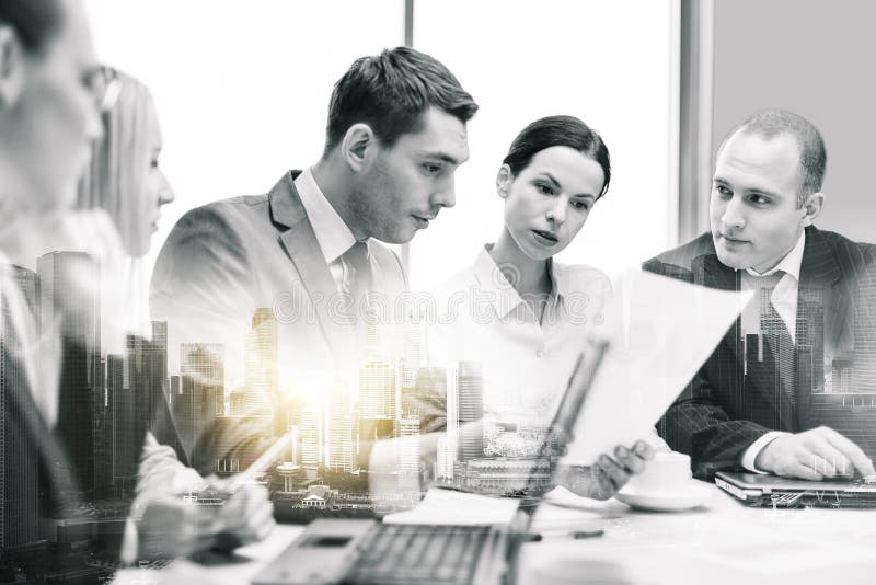 Business team with laptop and papers at office stock photos Business team with laptop and papers at office stock photos
