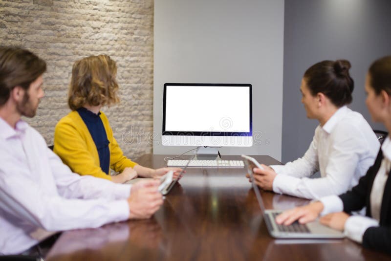 Business team looking at computer screen in the meeting room royalty free stock photography