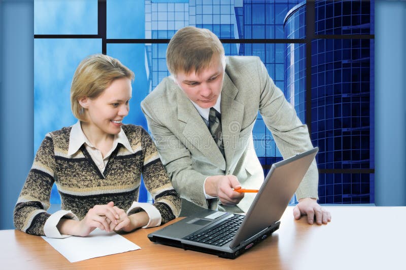 Business team man and woman work in office on laptop with view business buildings