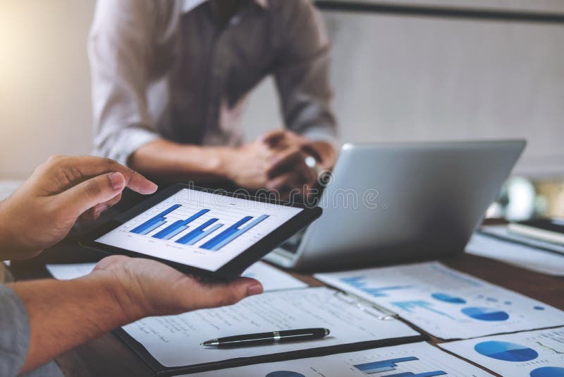Business team meeting working with new startup project, discussion and analysis data the charts and graphs. Digital tablet stock image