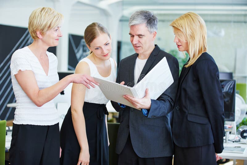 Business team in office doing planning with files stock photos Business team in office doing planning with files stock photos