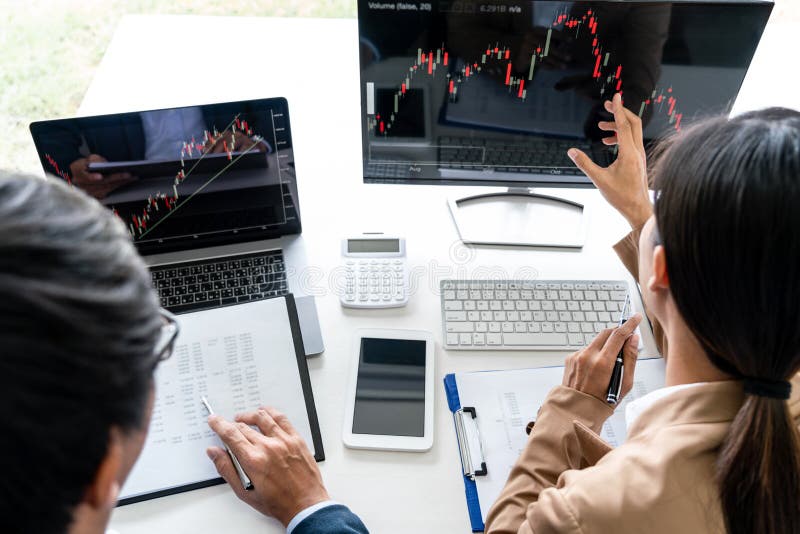 Business team partner working with computer, laptop, discussion and analyzing graph stock market trading with stock chart data royalty free stock image Business team partner working with computer, laptop, discussion and analyzing graph stock market trading with stock chart data royalty free stock image