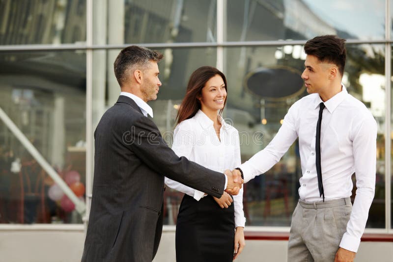 Business Team. People shake hands communicating with each other stock photography
