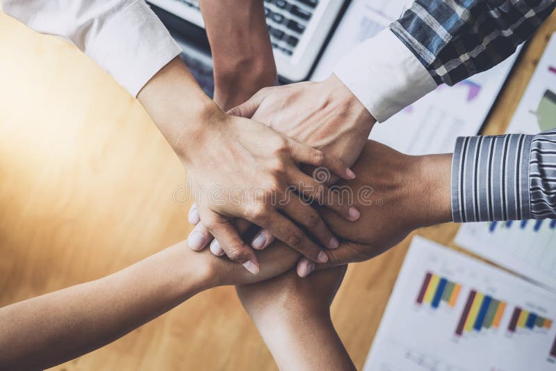 Business team shaking hands of unity after a meeting to sign agreement and become partner in the office, contract between their f stock images