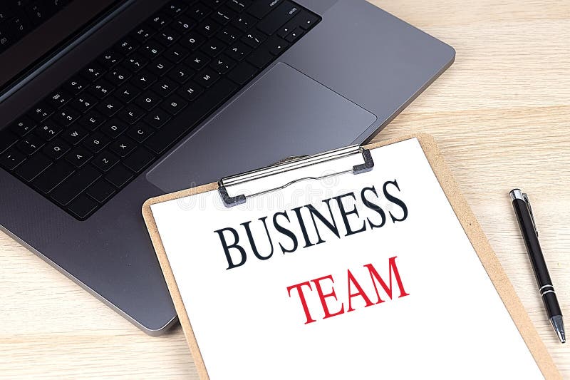 BUSINESS TEAM text on clipboard on laptop royalty free stock images