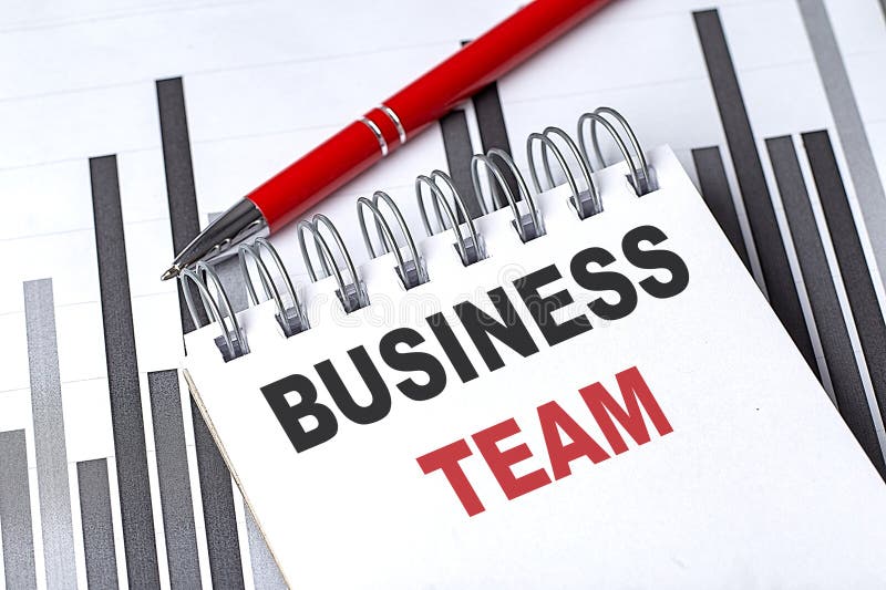 BUSINESS TEAM text written on notebook with pen on chart royalty free stock image