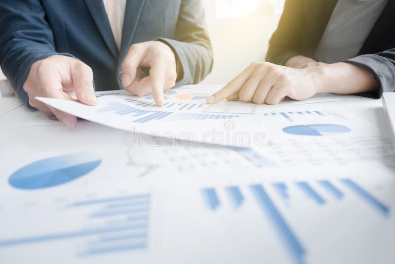 Business team two colleagues discussing financial graph data on stock photography
