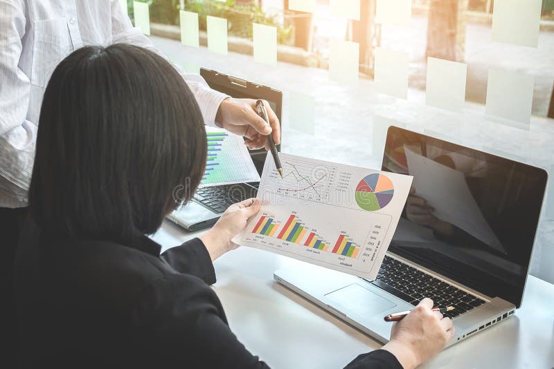 Business team two colleagues discussing new plan financial graph royalty free stock photos