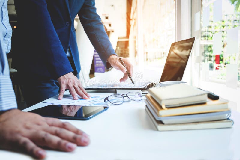 Business team two colleagues discussing new plan financial graph stock image