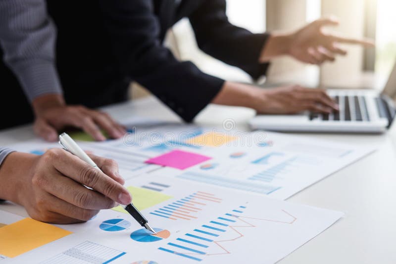 Business team two colleagues discussing working with many document graph in team Meeting Talking Brainstorming Communication royalty free stock photography