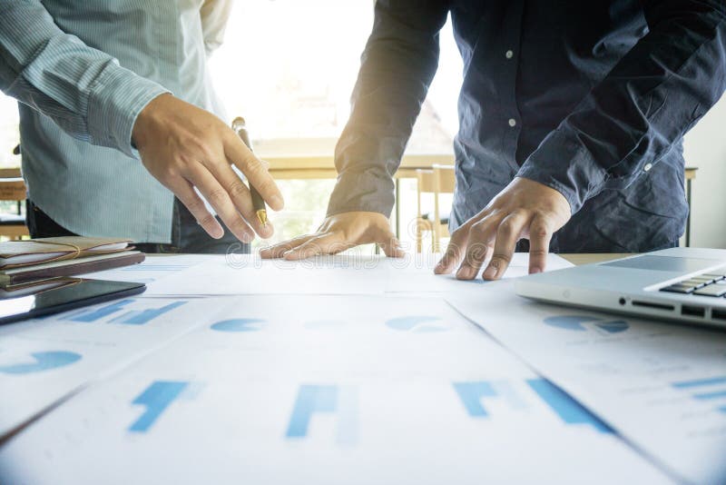 Business team two colleagues discussing working with many document graph in team Meeting Talking Brainstorming Communication royalty free stock image