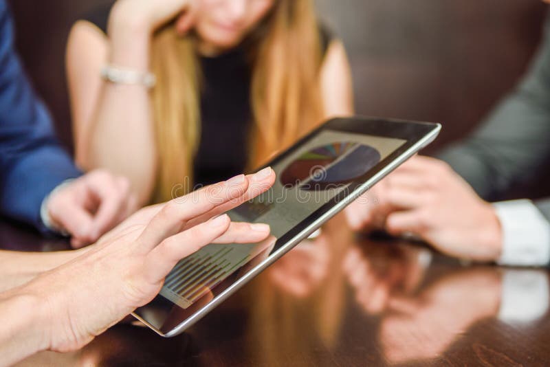 Business team using tablet computer to work with financial data