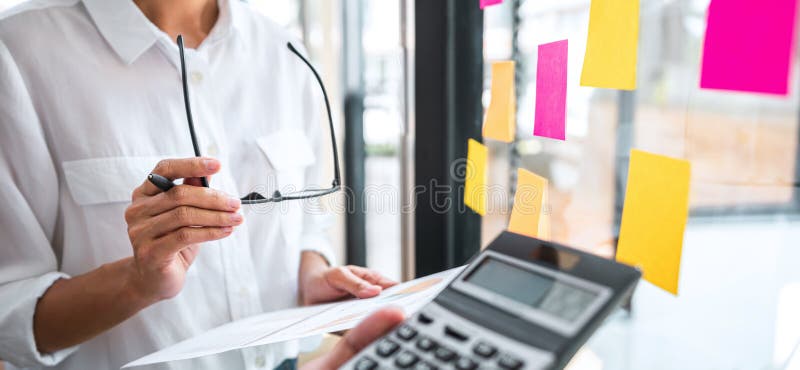 Business team working marketing growth on financial document graph report statistics, using post it notes in glass wall to writing royalty free stock photography